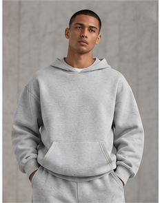 Model wearing the Relaxed Performance Hoodie in heather grey, front view