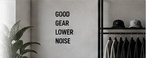 A rail of ITurntItDown garments beside a wall reading Good Gear Lower Noise