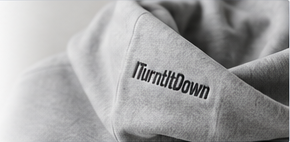 A sleeve of a grey ITurntItDown sweatshirt